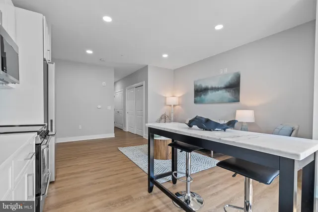 a view of a workspace with furniture and wooden floor