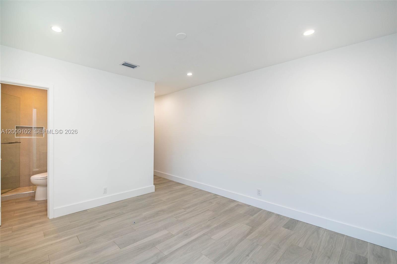 330 Southwest 27th Road Miami, FL 33129 - Photo 18 of 62 an empty room with wooden floor and entrance