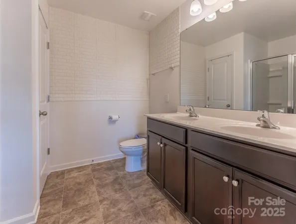 a bathroom with a granite countertop sink a mirror and a shower