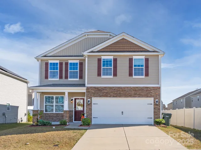 a front view of a house with a garage