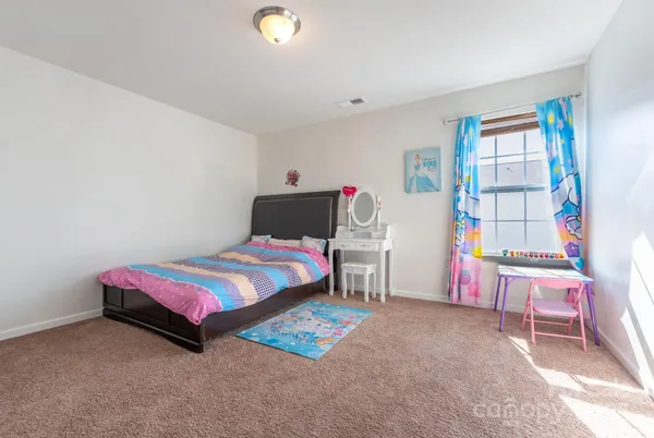 a view of a house with a big yard and large tree