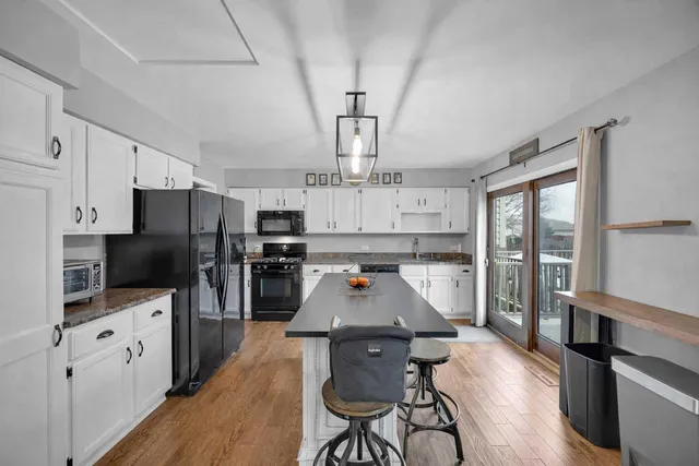 a large kitchen with lots of counter space and wooden floor