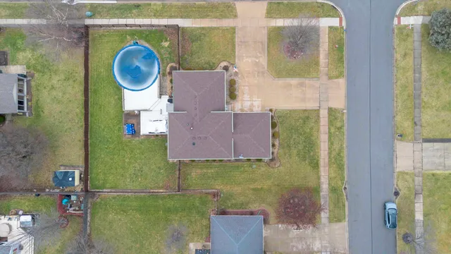 an aerial view of residential house with outdoor space and parking