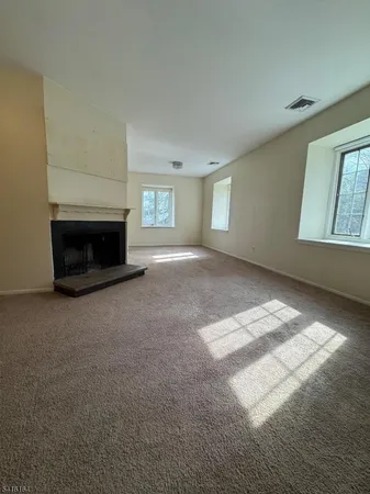 a view of empty room with a fireplace