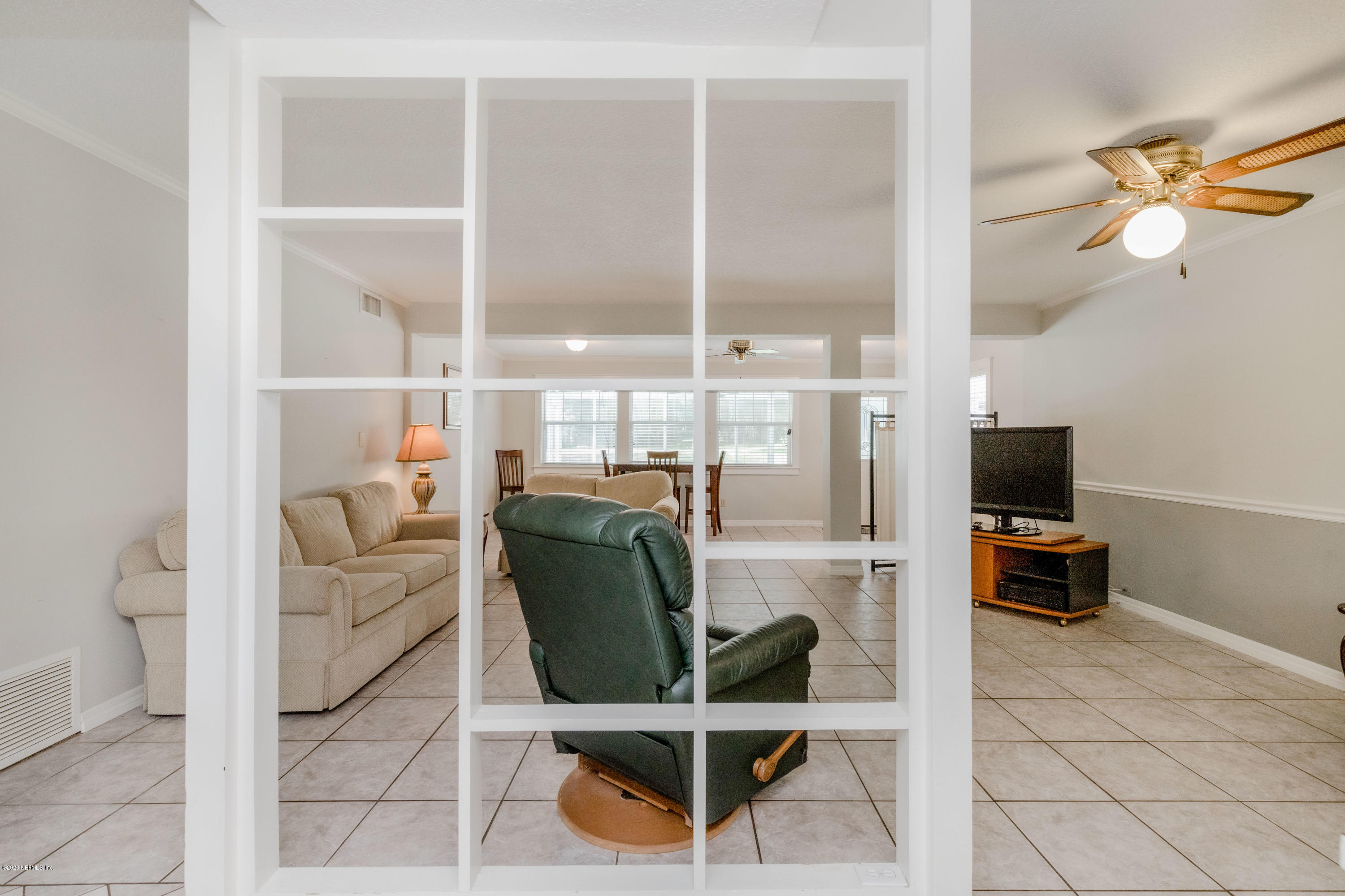 3118 Kline Road Jacksonville, FL 32246 - Photo 15 of 39 a living room with furniture a flat screen tv and kitchen view