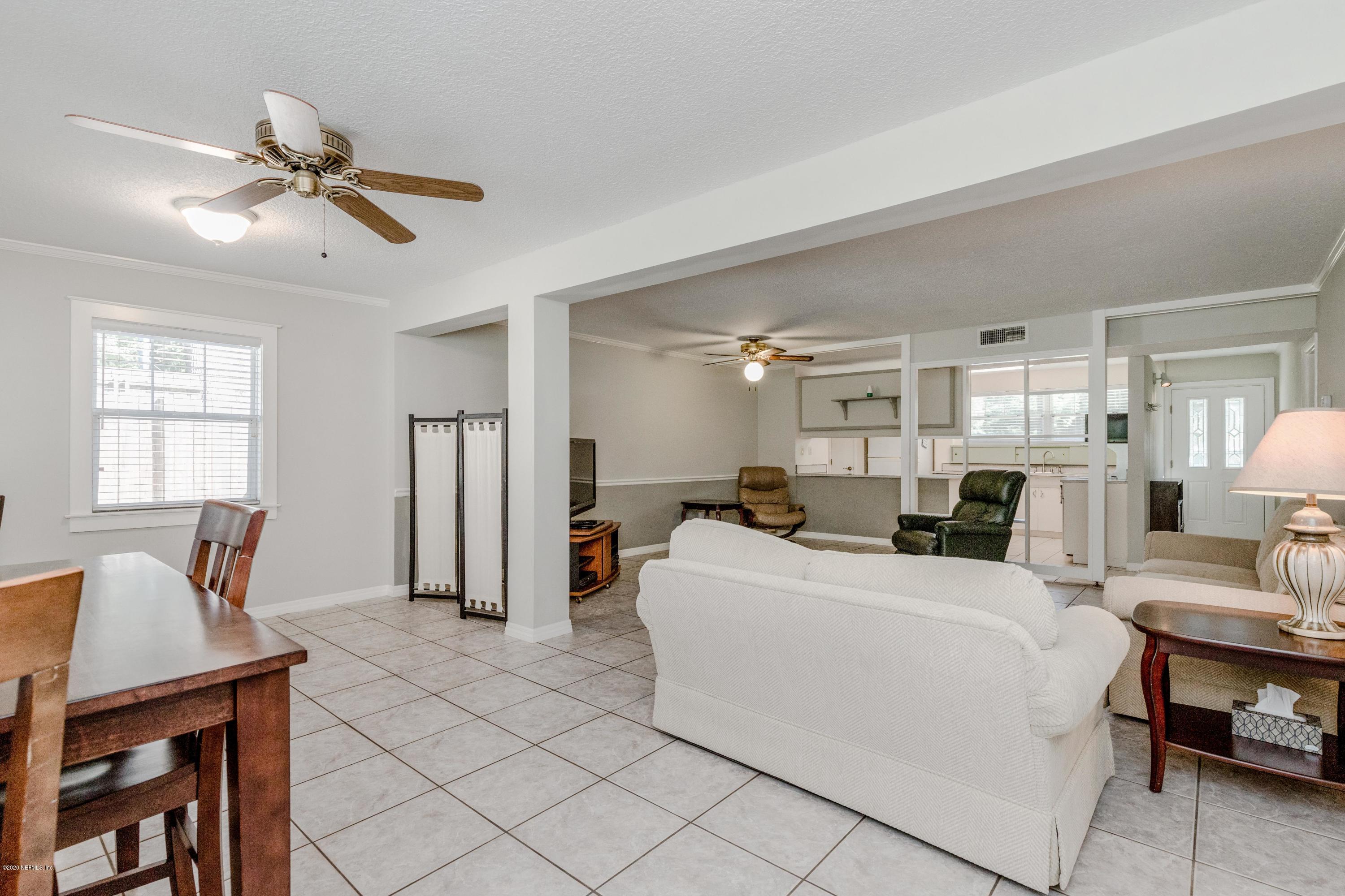 3118 Kline Road Jacksonville, FL 32246 - Photo 17 of 39 a living room with furniture a table and wooden floor