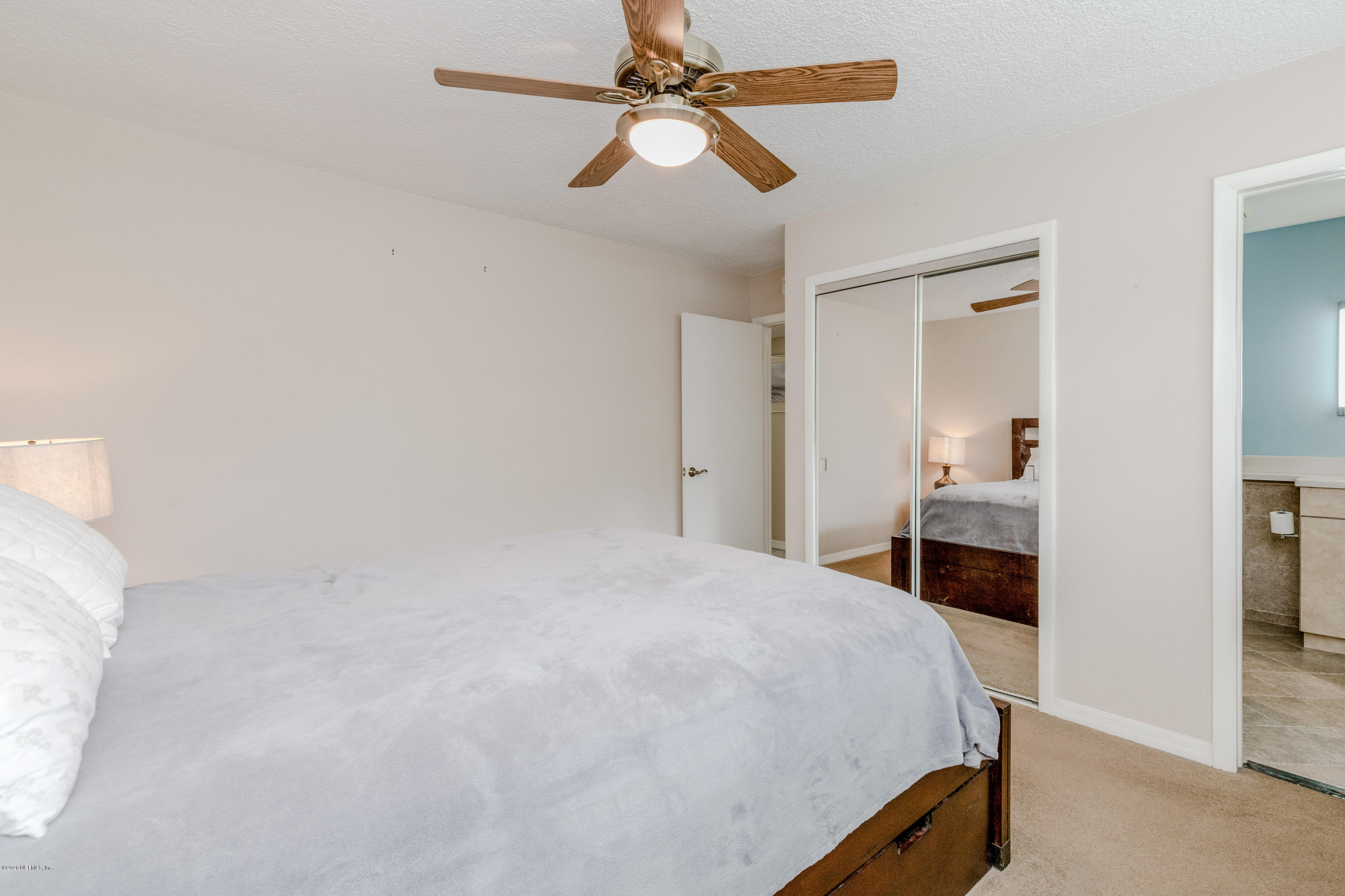 3118 Kline Road Jacksonville, FL 32246 - Photo 21 of 39 a bedroom with a bed and a chandelier