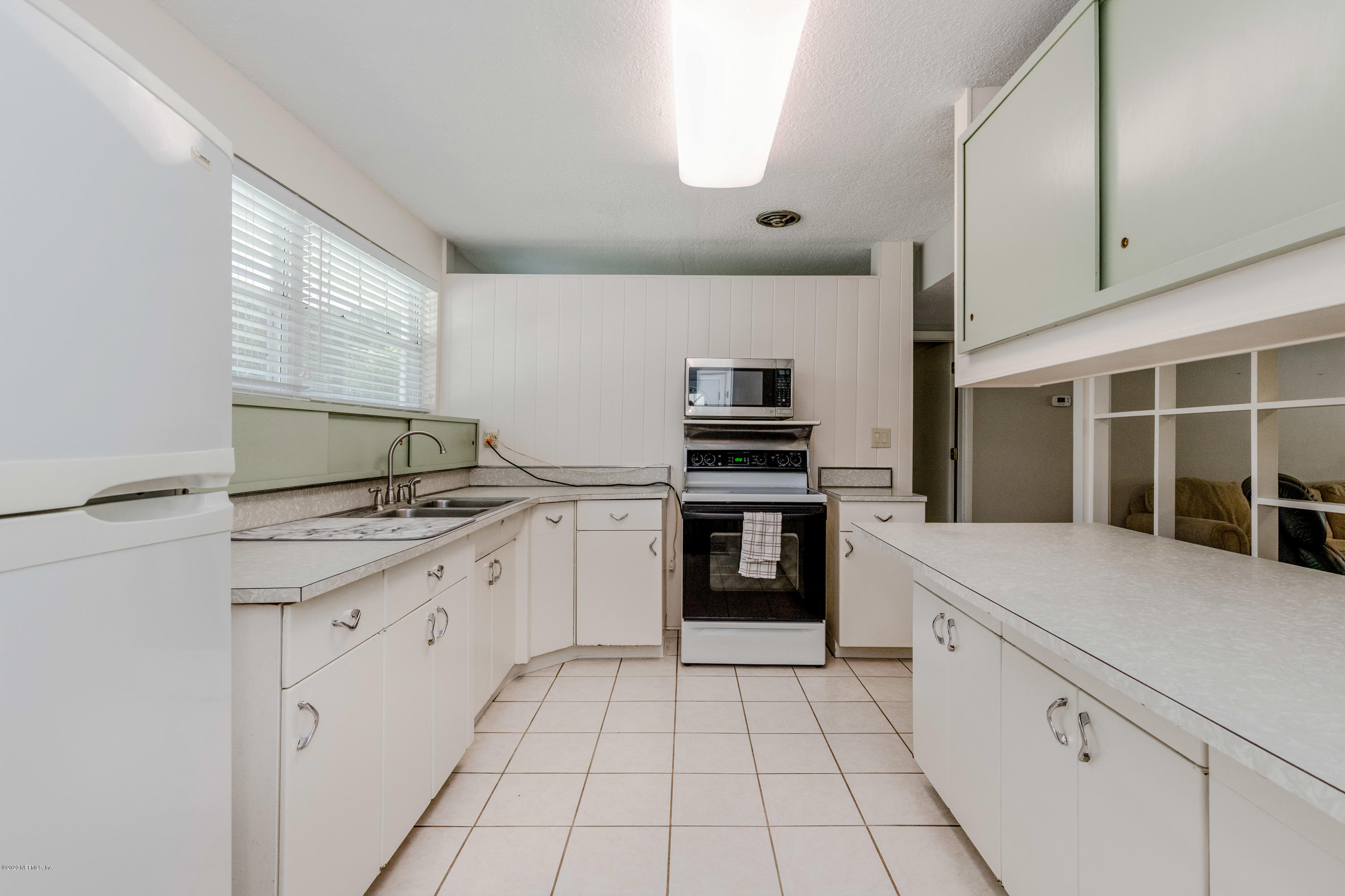 3118 Kline Road Jacksonville, FL 32246 - Photo 8 of 39 a kitchen with granite countertop a stove sink and cabinets