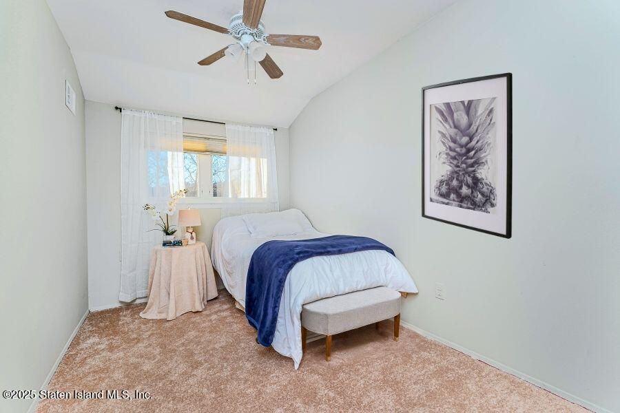 21 Alan Loop Staten Island, NY 10304 - Photo 19 of 27 a spacious bedroom with a bed and a painting on the wall