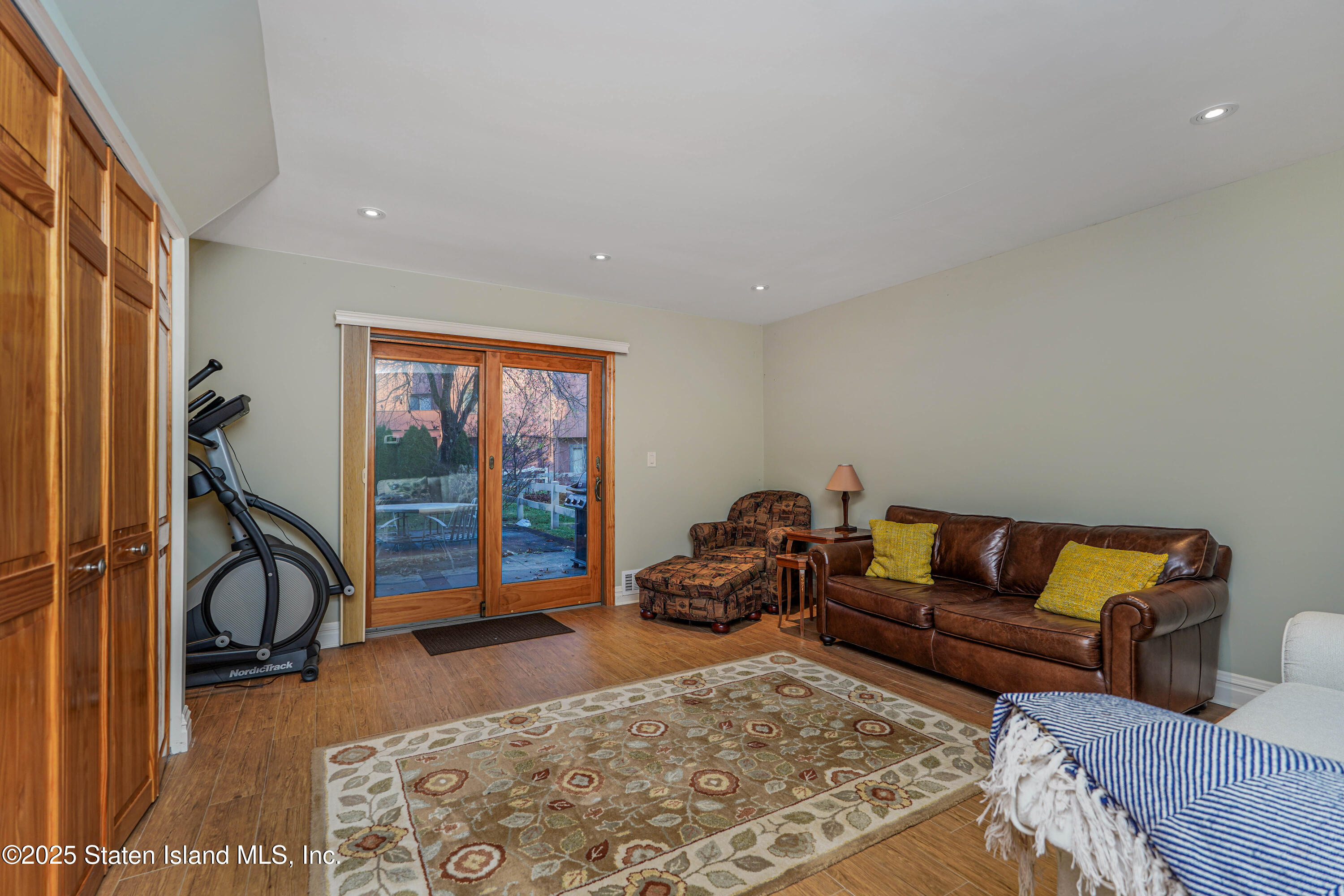 21 Alan Loop Staten Island, NY 10304 - Photo 21 of 27 a living room with furniture a rug and a flat screen tv