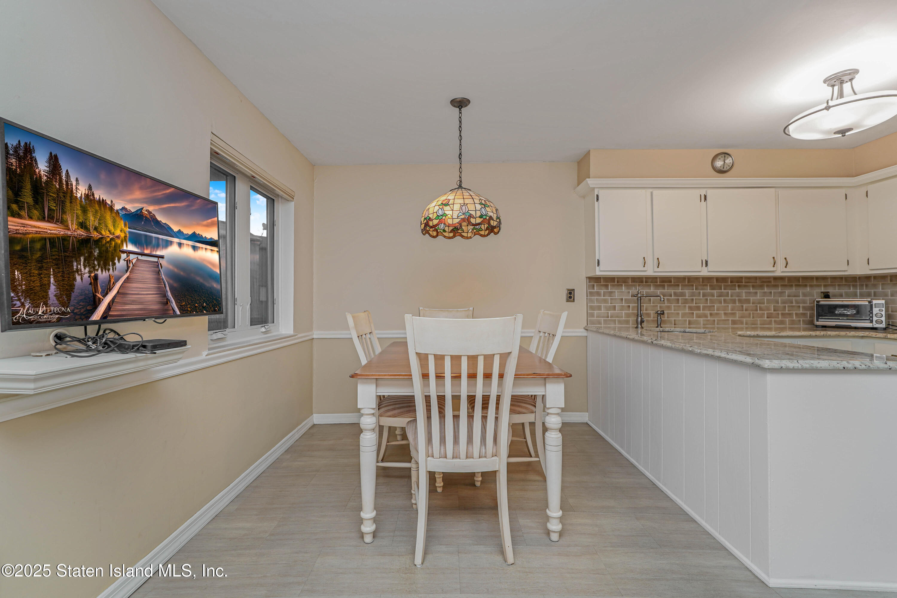 21 Alan Loop Staten Island, NY 10304 - Photo 9 of 27 a view of a kitchen with kitchen island dining table and chairs