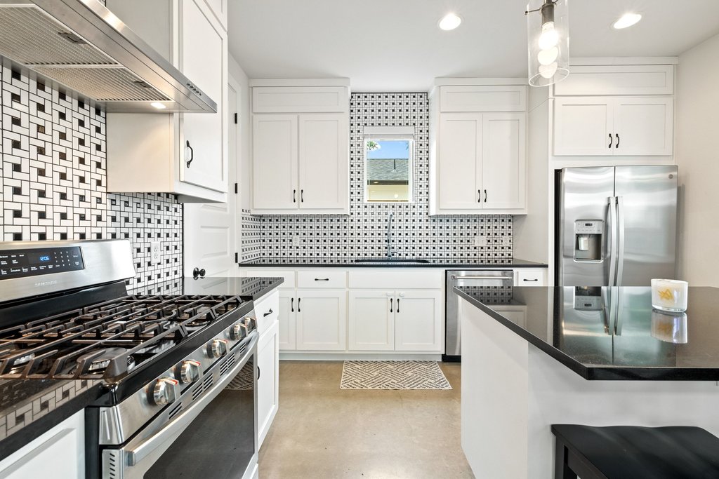 1182 Ridgeway Drive, Unit A Austin, TX 78702 - Photo 14 of 35 a kitchen with granite countertop a stove and a sink