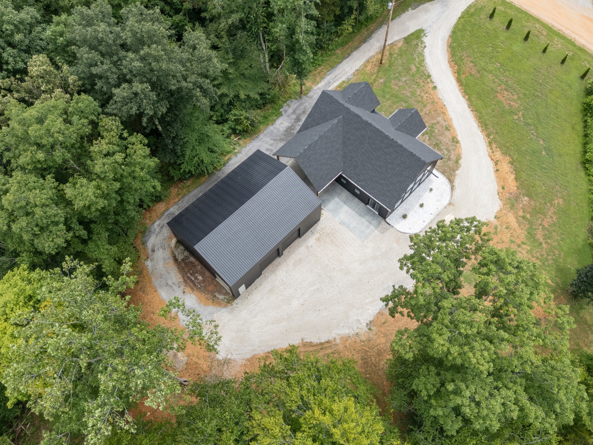 7922 East Plunders Creek Road Dickson, TN 37055 - Photo 84 of 86 an aerial view of a house with a yard and trees all around