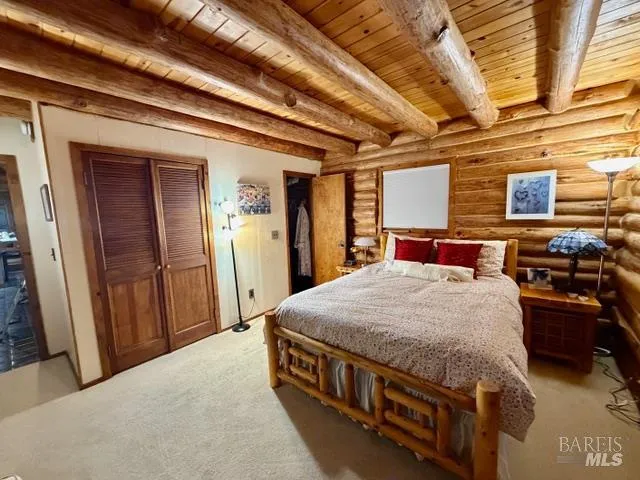 a bed sitting in a bedroom next to a window