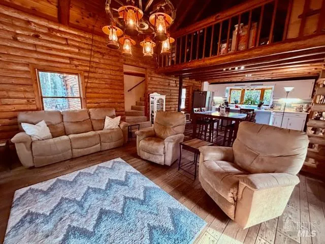 a living room with furniture a fireplace and a large window