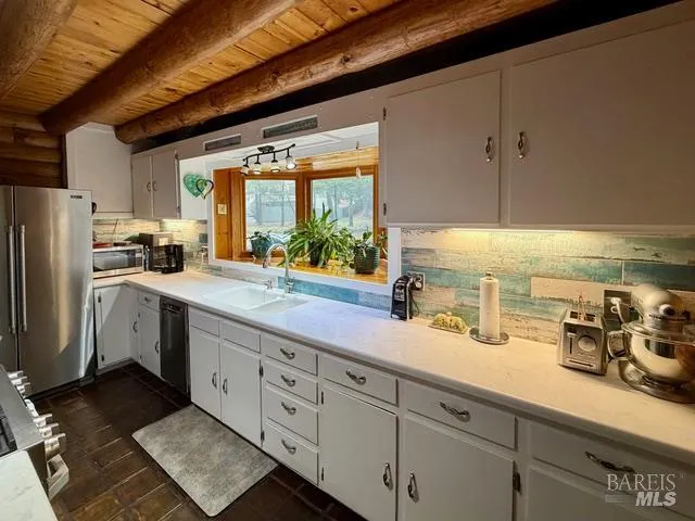 a kitchen with counter top space cabinets and stainless steel appliances