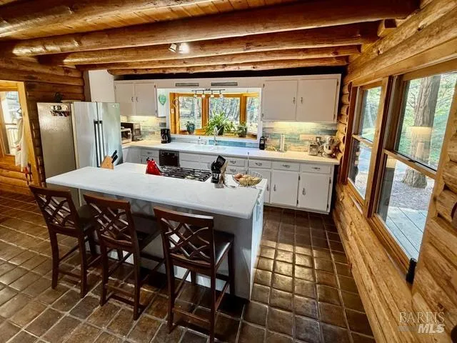 a kitchen with stainless steel appliances granite countertop a sink and cabinets