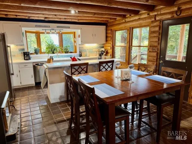 a view of a dining room with furniture and window