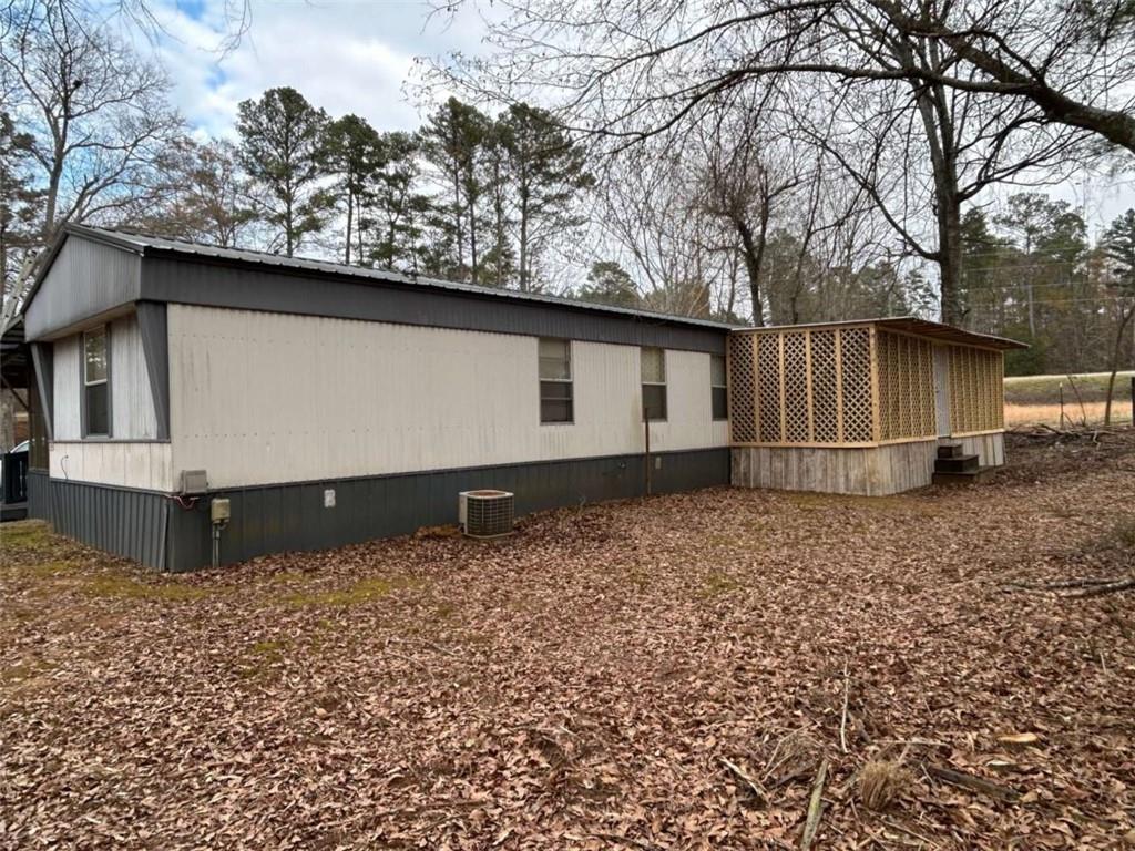 1544 Dry Creek Road Cedartown, GA 30125 - Photo 4 of 13 a backyard of a house with wooden fence