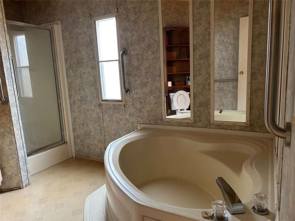 1544 Dry Creek Road Cedartown, GA 30125 - Photo 10 of 13 a bath tub sitting in a bathroom next to a window