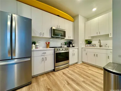 a kitchen with a refrigerator stove and sink
