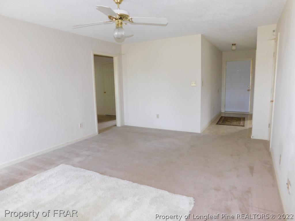 541 Camden Road Raeford, NC 28376 - Photo 11 of 24 an empty room with a ceiling fan and carpet