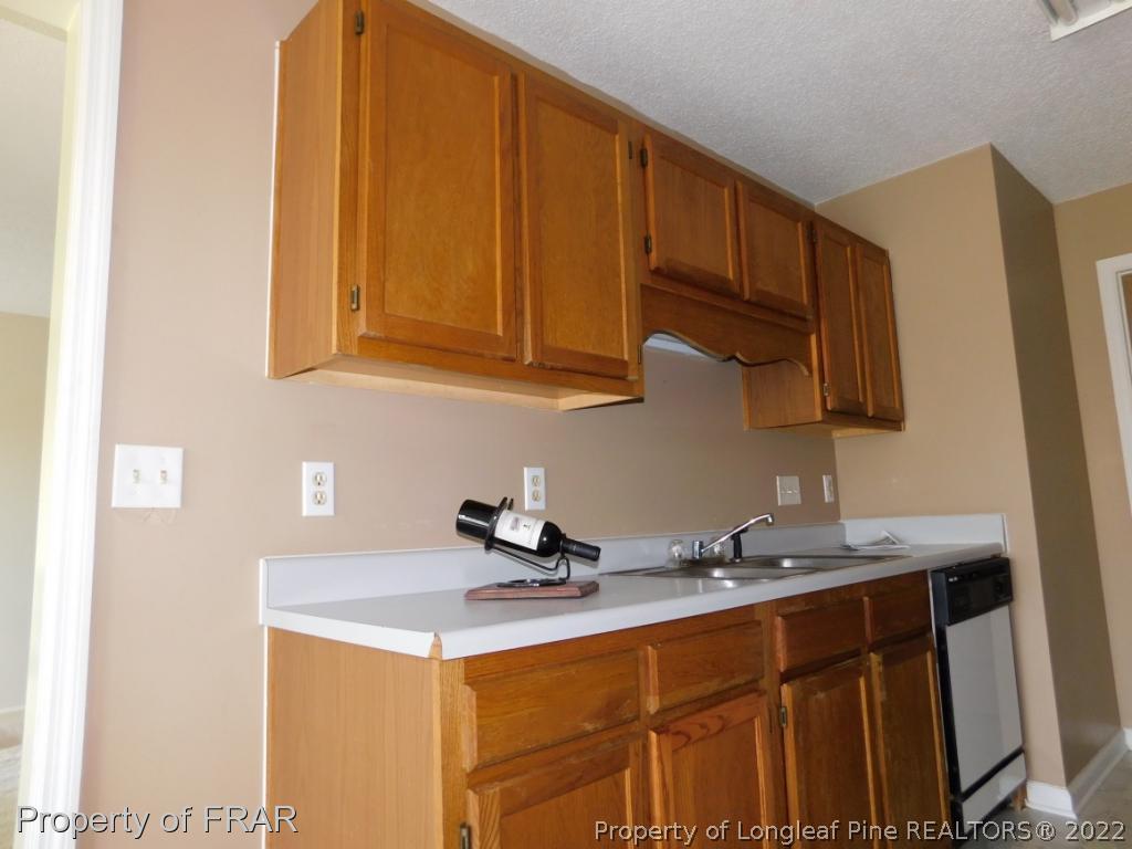 541 Camden Road Raeford, NC 28376 - Photo 12 of 24 a kitchen with stainless steel appliances granite countertop a sink stove and cabinets