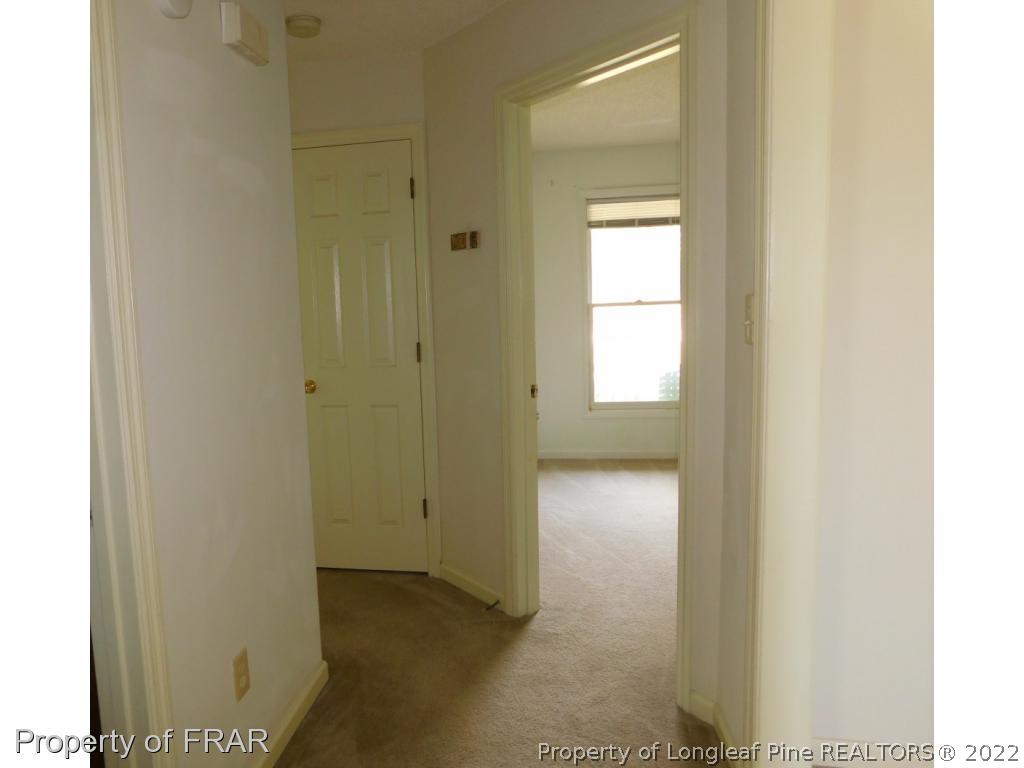 541 Camden Road Raeford, NC 28376 - Photo 19 of 24 a view of a hallway with wooden floor