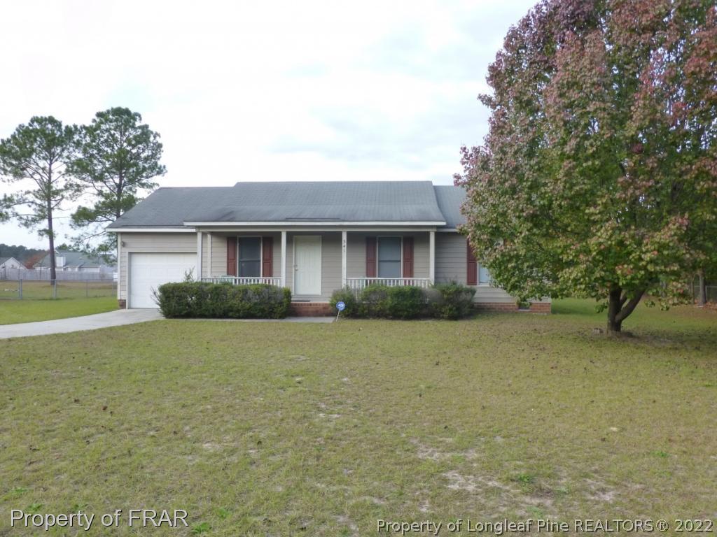 541 Camden Road Raeford, NC 28376 - Photo 2 of 24 a front view of house with yard and trees