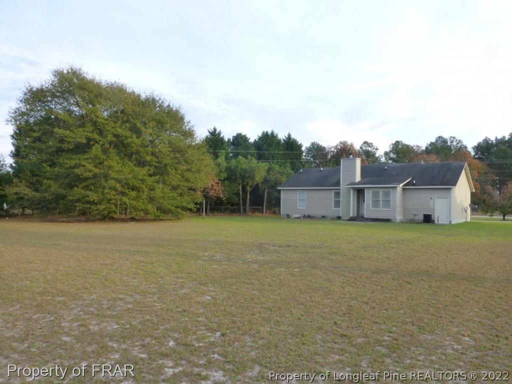 541 Camden Road Raeford, NC 28376 - Photo 23 of 24 a backyard of a house with lots of green space