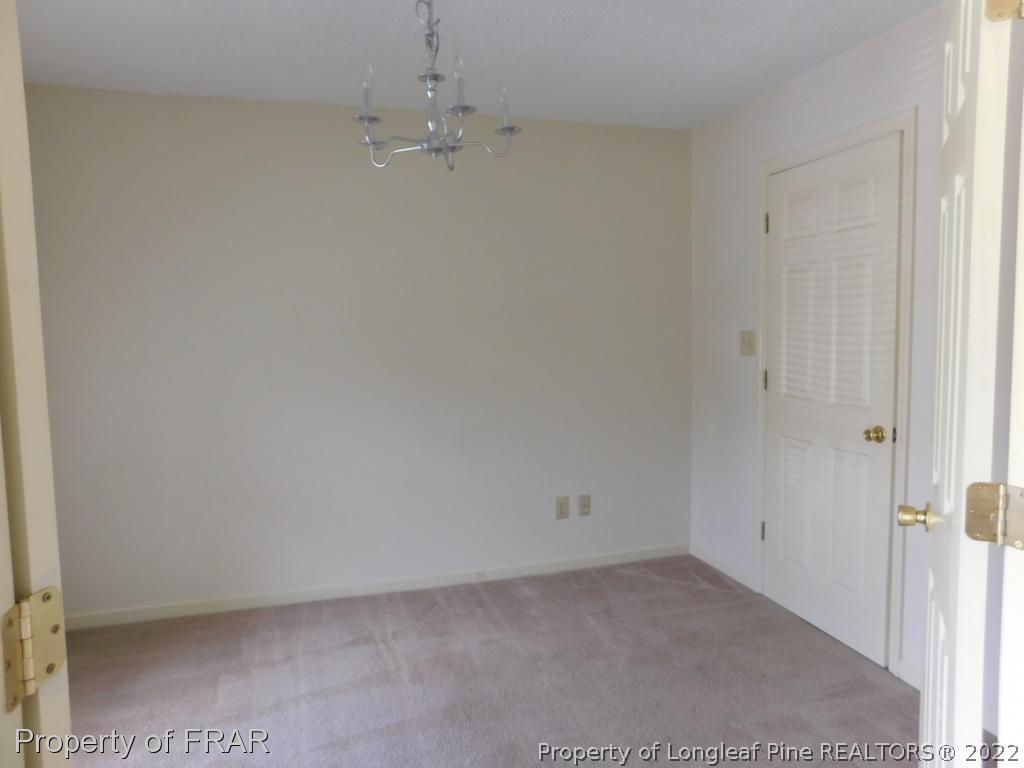541 Camden Road Raeford, NC 28376 - Photo 4 of 24 an empty room with a chandelier fan