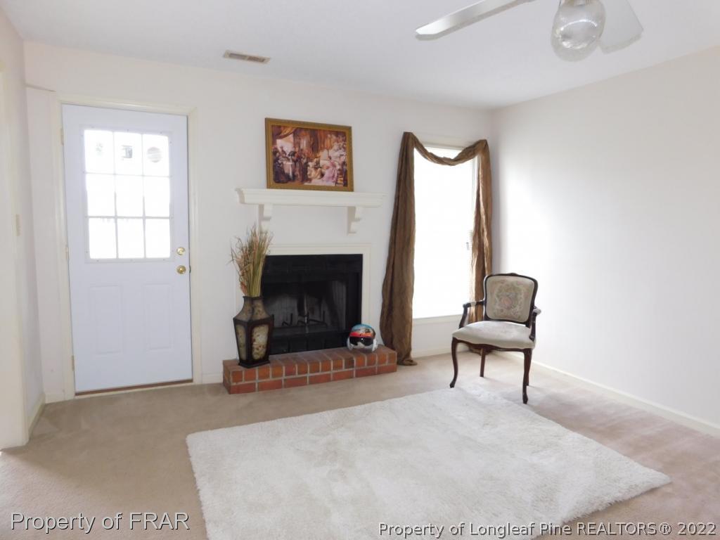 541 Camden Road Raeford, NC 28376 - Photo 9 of 24 a living room with furniture a fireplace and a window