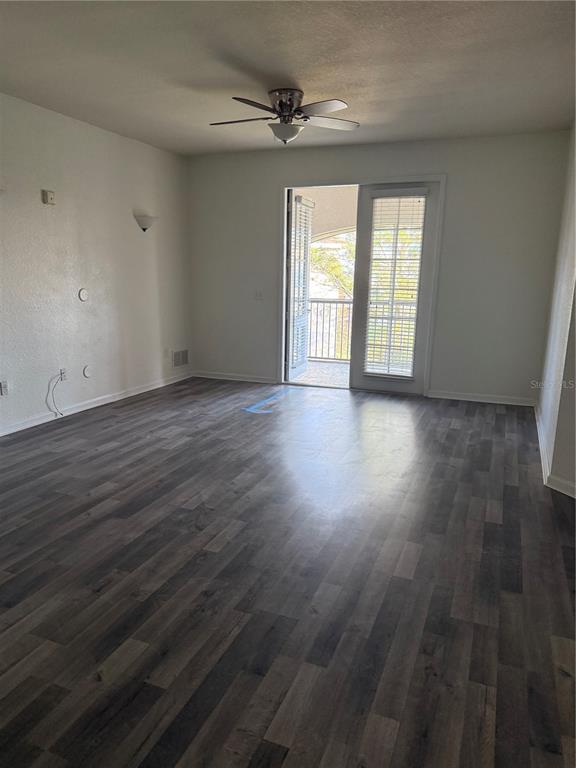 3051 Greystone Loop, Unit 304 Kissimmee, FL 34741 - Photo 16 of 32 an empty room with wooden floor and windows