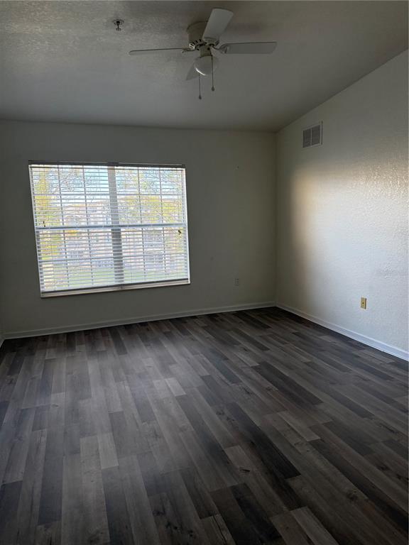3051 Greystone Loop, Unit 304 Kissimmee, FL 34741 - Photo 19 of 32 an empty room with wooden floor and windows