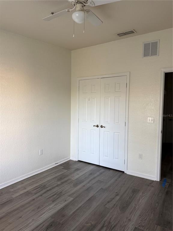 3051 Greystone Loop, Unit 304 Kissimmee, FL 34741 - Photo 20 of 32 a view of an empty room with wooden floor