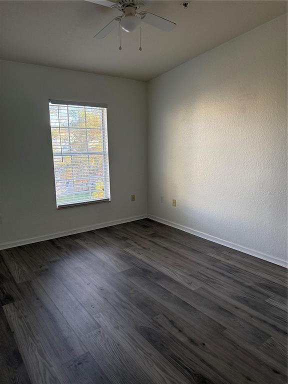 3051 Greystone Loop, Unit 304 Kissimmee, FL 34741 - Photo 21 of 32 an empty room with wooden floor and windows