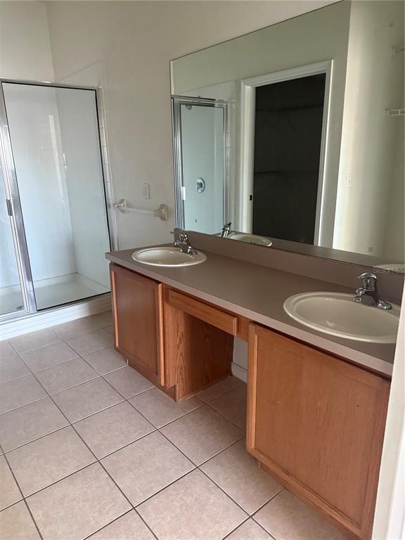 3051 Greystone Loop, Unit 304 Kissimmee, FL 34741 - Photo 23 of 32 a bathroom with a granite countertop sink and a mirror