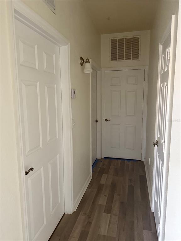 3051 Greystone Loop, Unit 304 Kissimmee, FL 34741 - Photo 25 of 32 a view of a bathroom with wooden floor and a shower