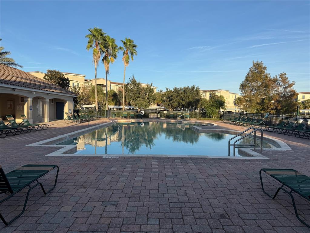 3051 Greystone Loop, Unit 304 Kissimmee, FL 34741 - Photo 29 of 32 a view of a swimming pool with a patio