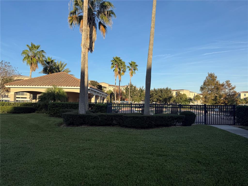 3051 Greystone Loop, Unit 304 Kissimmee, FL 34741 - Photo 30 of 32 a view of a yard with a house in the background