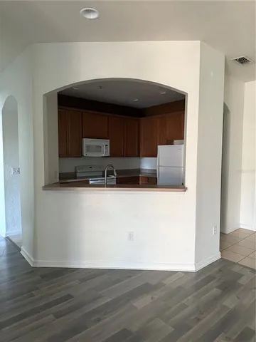 a kitchen with cabinets and a refrigerator