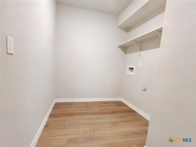 a view of a small space with wooden floor