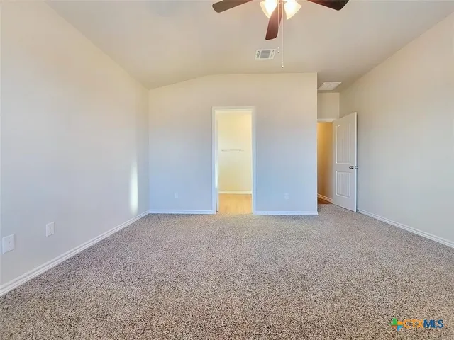 an empty room with a empty space and a ceiling fan
