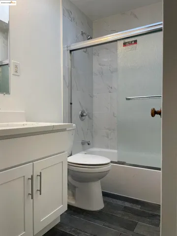 a bathroom with a white toilet and a shower