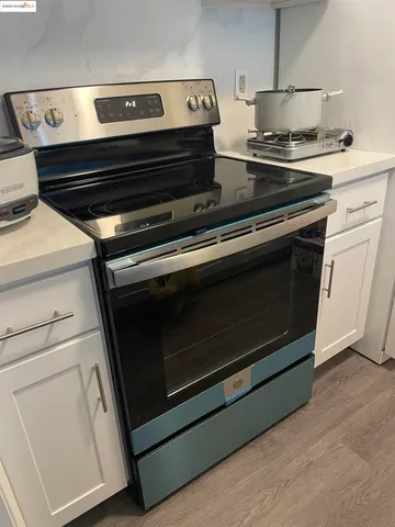 a stove top oven sitting inside of a kitchen