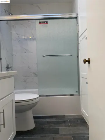 a bathroom with a shower and a toilet