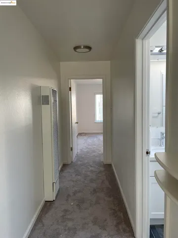 a view of a hallway with a wooden door