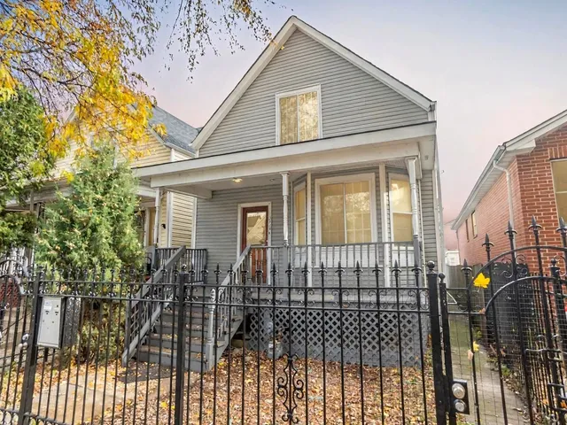 a view of a house with wooden fence