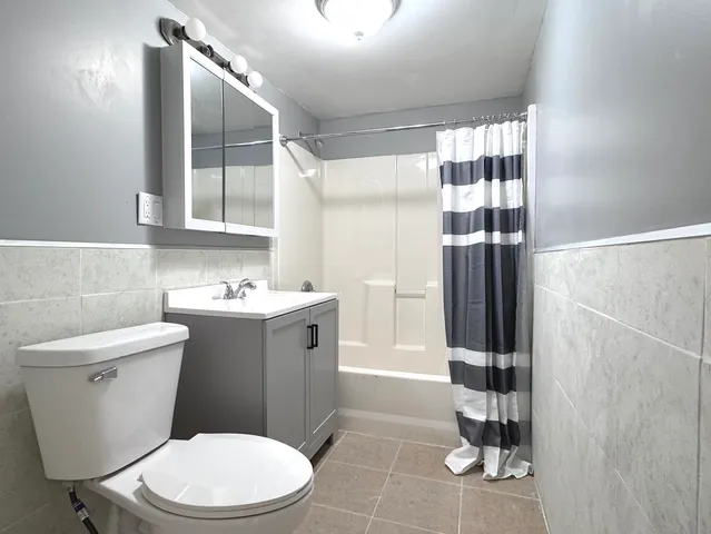 a bathroom with a toilet sink and shower