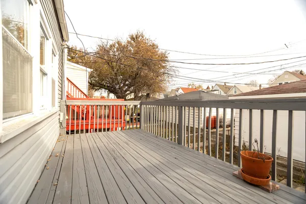 a balcony with wooden floor and fence